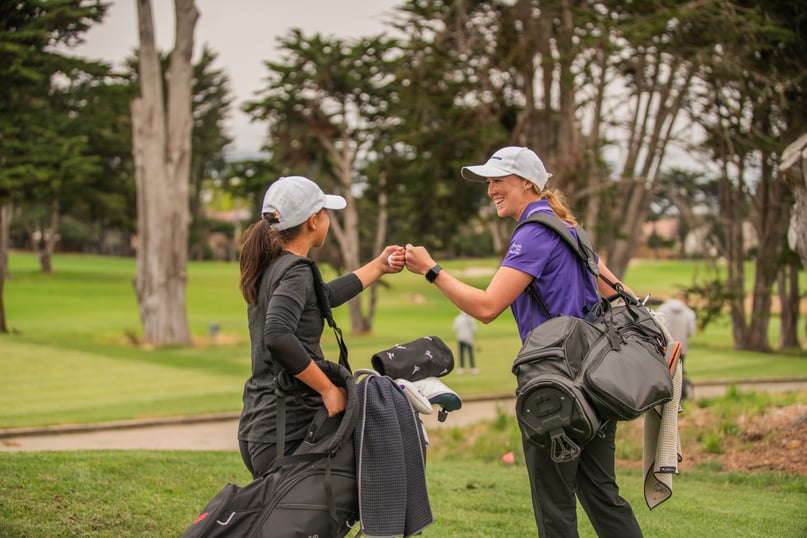 Youth high-fiving on golf course